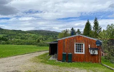 a small red building with a window on a field at Stunning Home In Eidsvåg I Romsdal in Toven