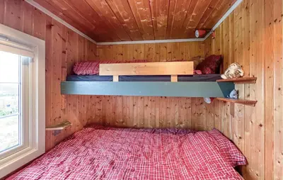 a bedroom with two bunk beds in a cabin at 2 Bedroom Cozy Home In Sjusjøen in Sjusjøen