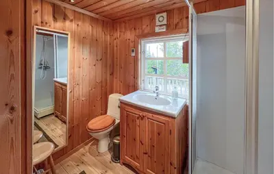 a bathroom with a toilet and a sink and a shower at 2 Bedroom Cozy Home In Sjusjøen in Sjusjøen