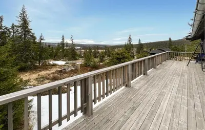 a wooden deck with a view of the woods at 2 Bedroom Cozy Home In Sjusjøen in Sjusjøen