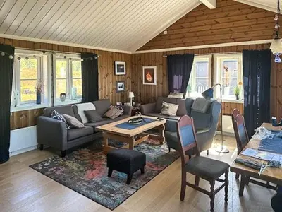 a living room with a couch and a table at Modern Cabin With Views In Lygna in Jaren