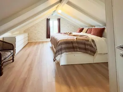 a bedroom with a bed in a attic at Hyggelig Gård Nær Bergen Med Spabad in Hjelmås