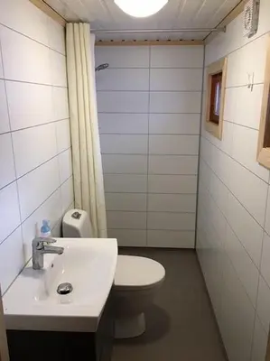 a small bathroom with a toilet and a sink at Koselig, lita hytte på Aurdalsåsen ved Danebu in Aurdal