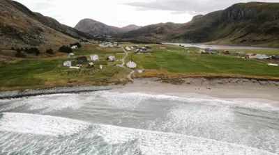 an aerial view of a beach and the ocean at Location, location, location in Ervik