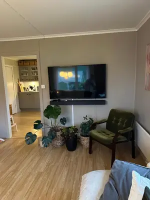 a living room with a flat screen tv on a wall at Location, location, location in Ervik