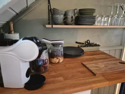 a counter top with jars and plates on it at Trines Hjerterom in Steinkjer