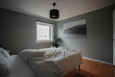 a bedroom with a bed and a window at Beach apartment with unique view in Ervik