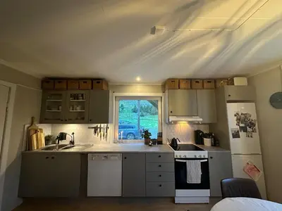 a small kitchen with a sink and a window at Location, location, location in Ervik