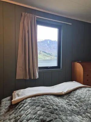 a bed in a bedroom with a window at Granli-Apartment in Stryn