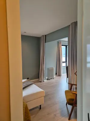 a bedroom with a bed and a chair at Granli-Apartment in Stryn