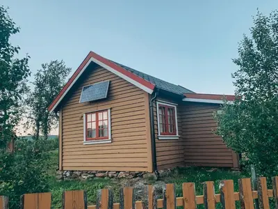 a house with a solar panel on top of it at Koselig hytte på hugastølen in Vang I Valdres