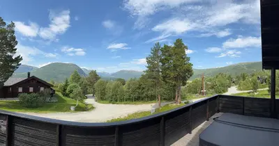a balcony with a view of a road and mountains at No 105 Kongelberget in Bjorli