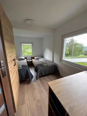 a room with two beds and a window at Cozy apartment in Tennfjord in Tennfjord