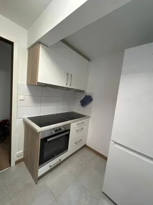 a small kitchen with a stove and a refrigerator at Cozy apartment in Tennfjord in Tennfjord