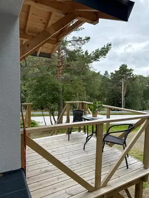 a wooden deck with a table and chairs on it at Cozy apartment in Tennfjord in Tennfjord