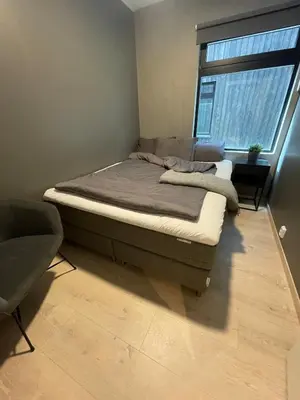 a bed sitting in a room with a window at Familiy apartment in Myrkdalen Voss in Vossestrand