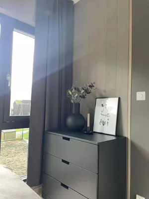 a bedroom with a dresser with a vase on it at Familiy apartment in Myrkdalen Voss in Vossestrand