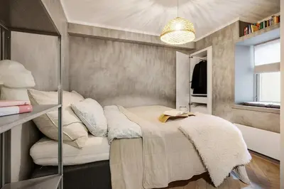 a bedroom with a bed and a mirror at Central apt in the centre of Bergen in Bergen