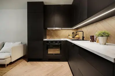 a kitchen with black cabinets and a sink at Central apt in the centre of Bergen in Bergen