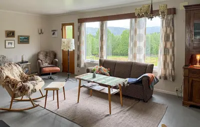 a living room with a couch and a table at 7 Bedroom Amazing Home In Nedre Vats in Stokka