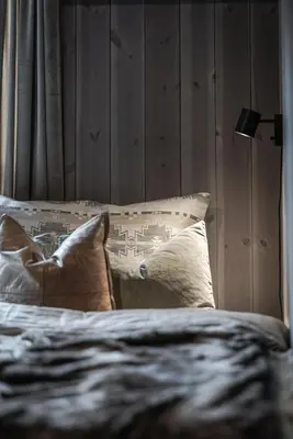 a bed with two pillows and a lamp on it at Penthouse with large rooftop terrace, Ski In-Ski Out in Hemsedal in Hemsedal