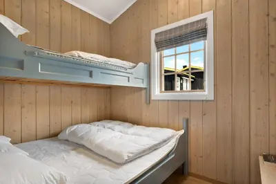 a room with two bunk beds and a window at Bitigrenda M in Beitostøl