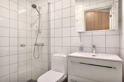 a bathroom with a shower and a toilet and a sink at Bitigrenda M in Beitostøl