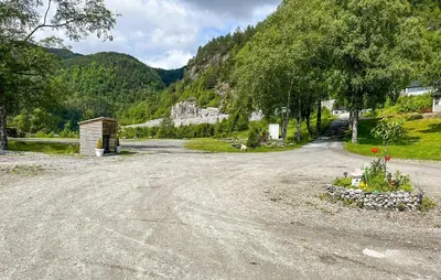 a dirt road with a building on the side of a mountain at 2 Bedroom Stunning Home In Lavik in Lavik