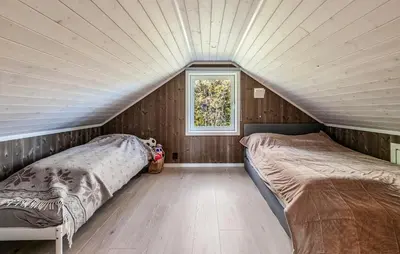two beds in a attic bedroom with a window at Amazing Home In Ål - With Wifi in Ål