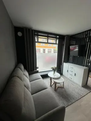 a living room with a couch and a tv at Cozy little apartment in Ålesund in Ålesund