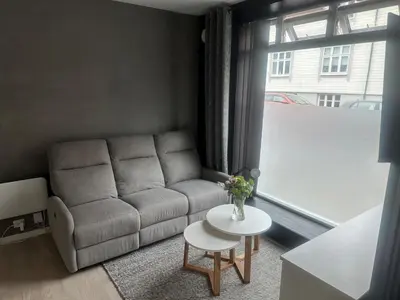 a living room with a couch and a table at Cozy little apartment in Ålesund in Ålesund
