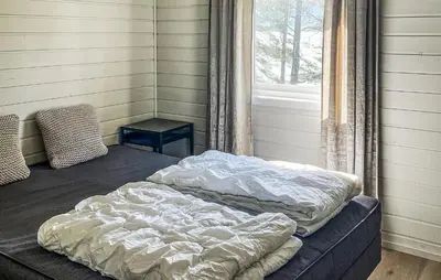 two beds in a room with a window at 2 Bedroom Awesome Home In Lavik in Lavik