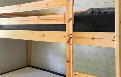 a bunk bed in a cabin with wood at 2 Bedroom Awesome Home In Lavik in Lavik