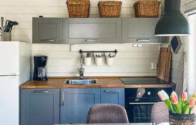 a kitchen with blue cabinets and a sink at 2 Bedroom Awesome Home In Lavik in Lavik
