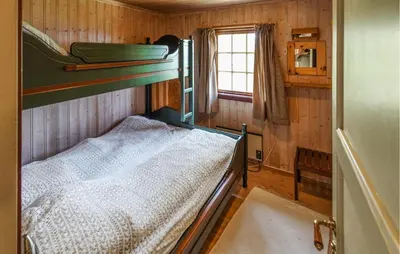 a bedroom with two bunk beds and a window at Awesome Home In Uvdal With Sauna in Uvdal