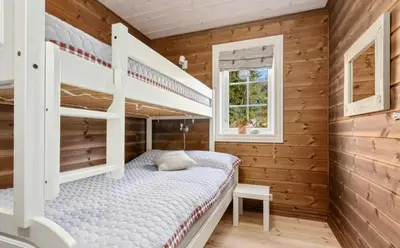 a bedroom with two bunk beds and a window at Family Cabin With Jacuzzi At Tempelseter in Eggedal