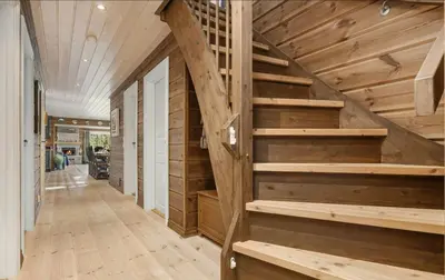 a hallway with wooden stairs in a house at Family Cabin With Jacuzzi At Tempelseter in Eggedal