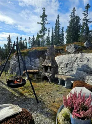 a garden with a bench and a fire pit at Family Cabin With Jacuzzi At Tempelseter in Eggedal