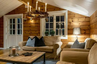a living room with a couch and a table at Spacious Family Cabin At Nesfjellet With Views in Nesbyen