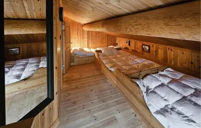 an overhead view of two beds in a wooden cabin at Cozy Home In Hemsedal With Sauna in Hemsedal
