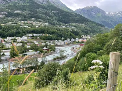 a town in the mountains with a river at Nyrenovert leilighet med 3 soverom i Odda sentrum in Odda