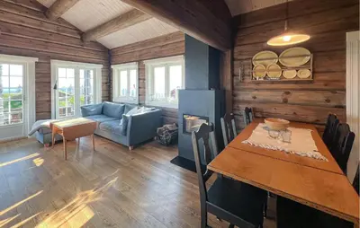a dining room with a table and a couch at Cozy Home In Sjusjøen With Wifi in Sjusjøen