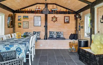 a dining room with a table and a bench at Cozy Home In Florø With Wifi in Florø