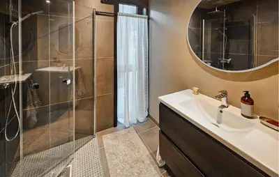 a bathroom with a sink and a shower with a mirror at Stunning Home In Nesbyen With Wifi in Nesbyen