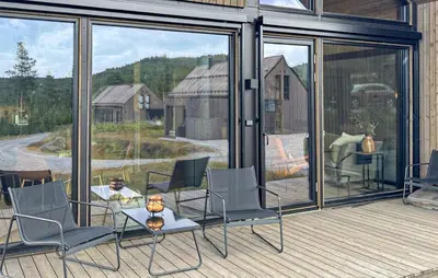 a patio with a table and chairs on a deck at Stunning Home In Nesbyen With Wifi in Nesbyen