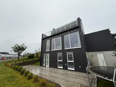 a black house with a lot of windows at Luksuriøs enebolig, nær Ålesund in Ytterland