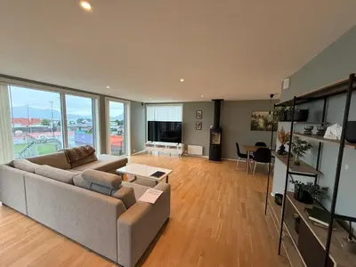 a living room with a couch and a table at Luksuriøs enebolig, nær Ålesund in Ytterland
