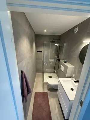 a bathroom with a sink and a toilet and a shower at Luksuriøs enebolig, nær Ålesund in Ytterland