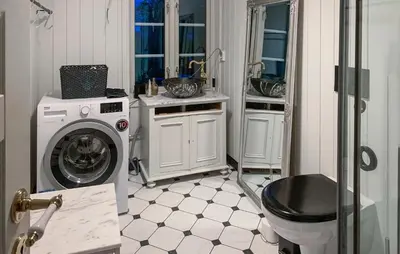 a bathroom with a washing machine and a sink at 2 Bedroom Awesome Home In Dovre in Dovre