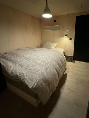 a bedroom with a large bed with a white comforter at Modern Cabin Near Auersvatn And Ski Trails in Hovden